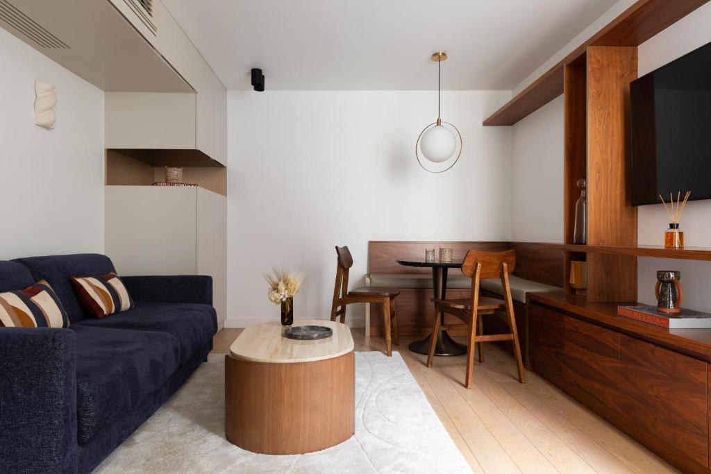 een woonkamer met een bank en een tafel bij HIGHSTAY - Luxury Serviced Apartments - Place Vendôme Area in Parijs