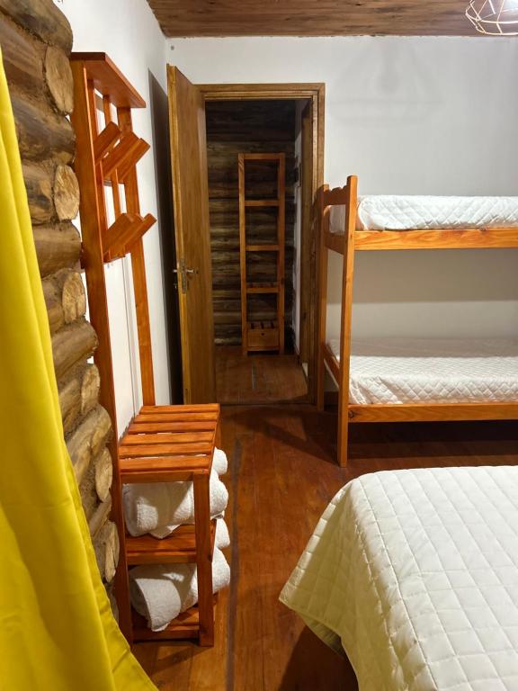Habitación con 2 literas, mesa y taburete en Cabañas Los Aires San Vicente en San Vicente