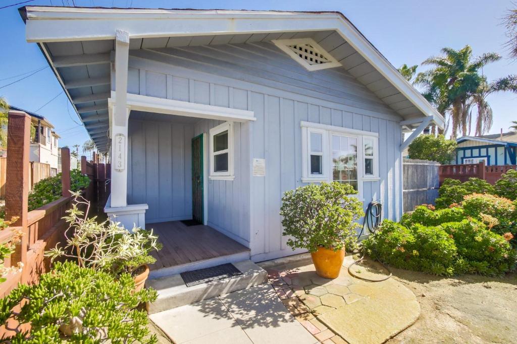 a blue tiny house with a porch at Ocean Beach Cottage in San Diego