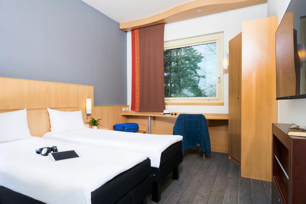 Postel nebo postele na pokoji v ubytování Ibis Como