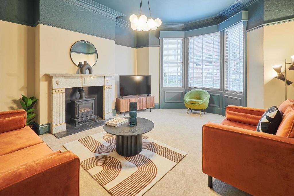 a living room with a couch and a fireplace at Host & Stay - Kittiwake House in Whitley Bay