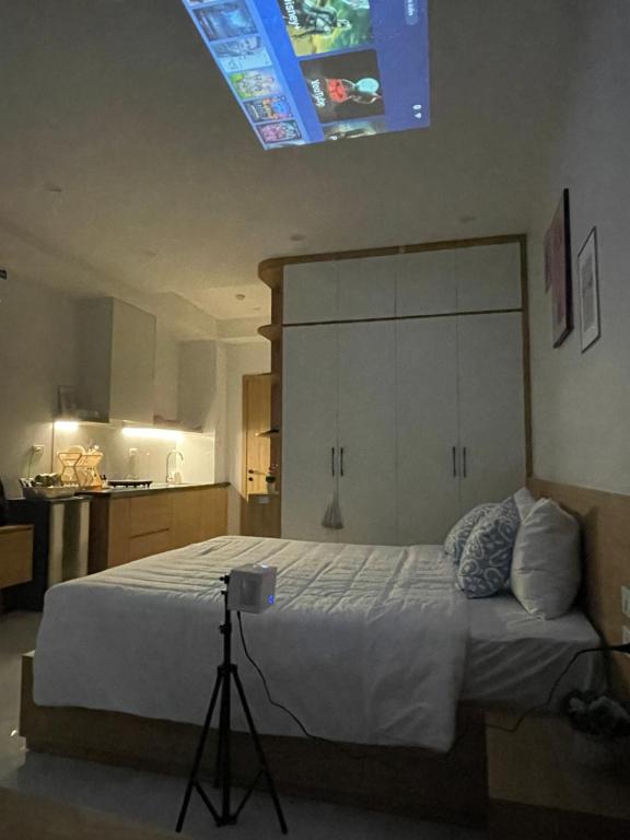 a bedroom with a large bed with a blue light at Dodo home AC in Hanoi