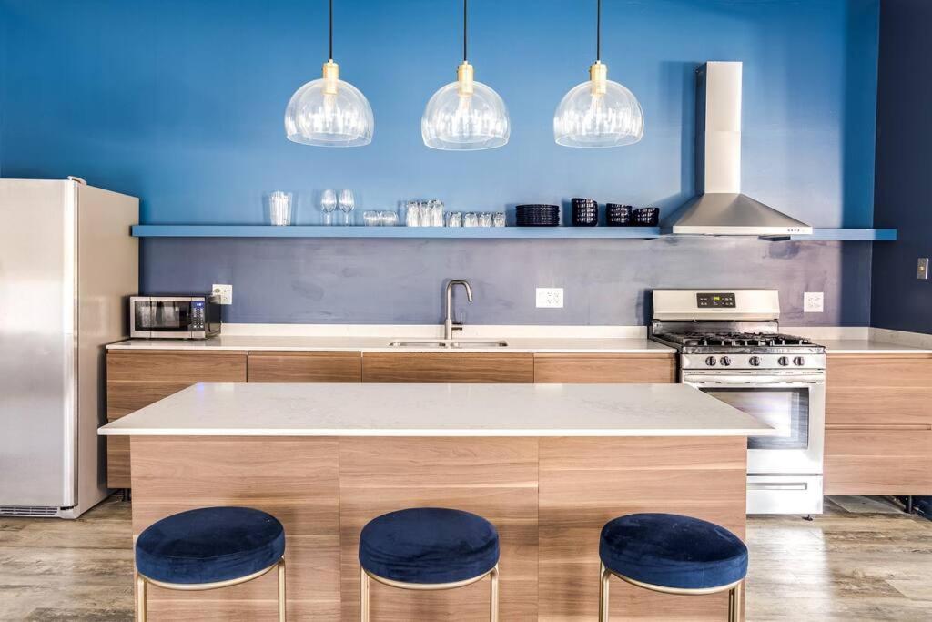 a kitchen with a counter with two blue stools at Downtown Penthouse with Private Rooftop #2S in Chicago