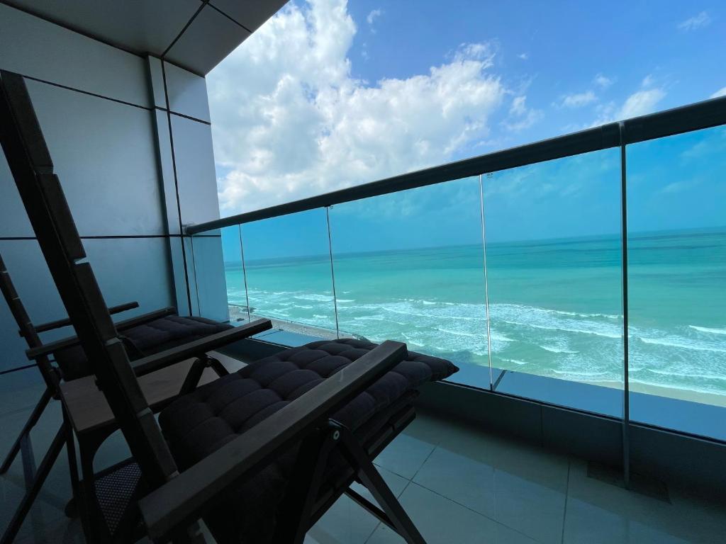 a room with a chair and a view of the ocean at Luxurious Sea View - Beach Front in Ajman 