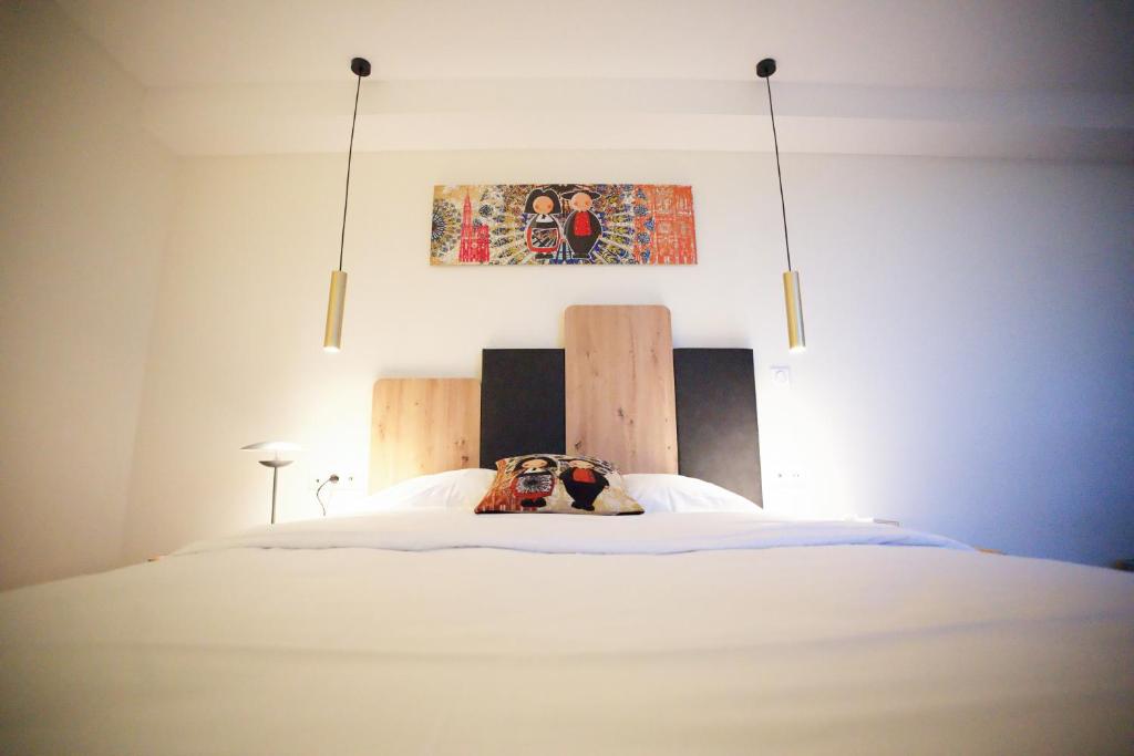 Postel nebo postele na pokoji v ubytování Arrow Hôtel