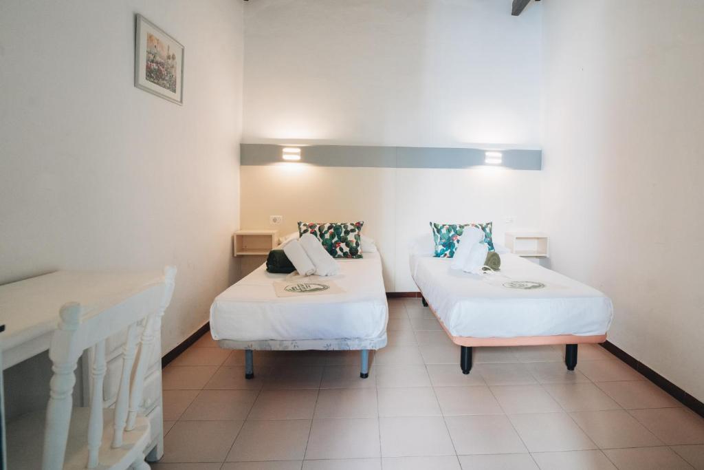 Postel nebo postele na pokoji v ubytování Hostal Colón
