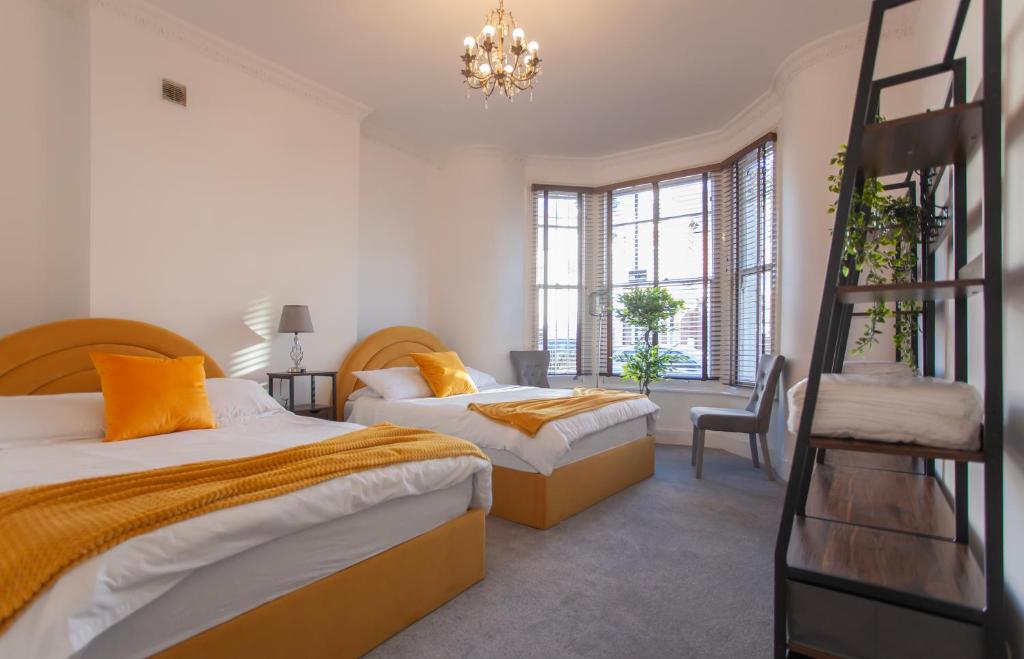 a bedroom with two beds and a ladder at Templar large garden flat in London