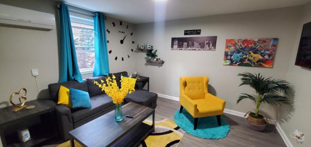 a living room with a couch and a yellow chair at Cozy Nashville Duplex Unit B in Nashville