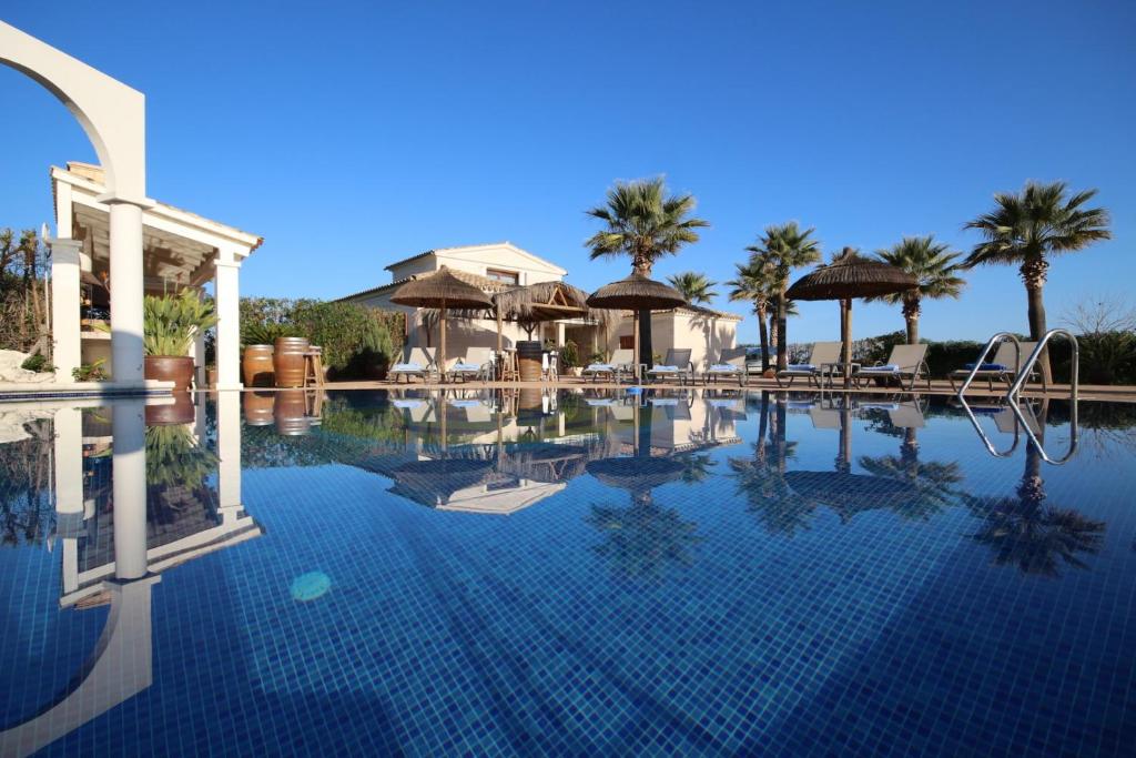 een zwembad in een resort met palmbomen bij Sa Pobla - 1583 Mallorca in Sa Pobla
