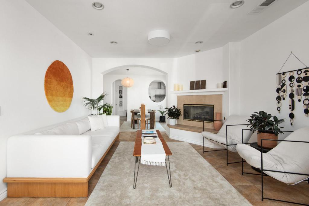 a living room with a white couch and a table at Modern beach home with rooftop - Ocean View! in Oceanside