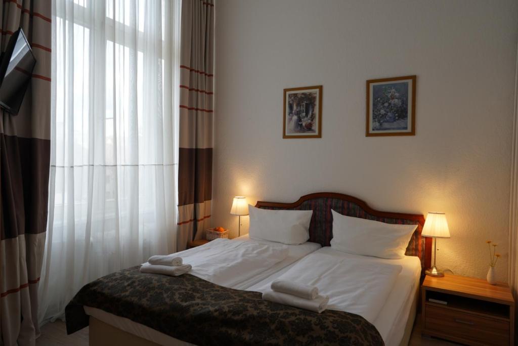 Ένα ή περισσότερα κρεβάτια σε δωμάτιο στο City Pension Berlin