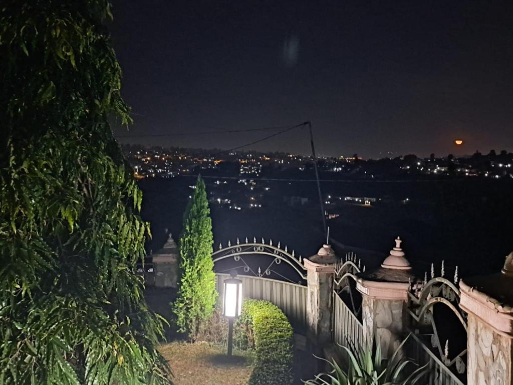 a bridge over a body of water at night at Green Valley in Kigali