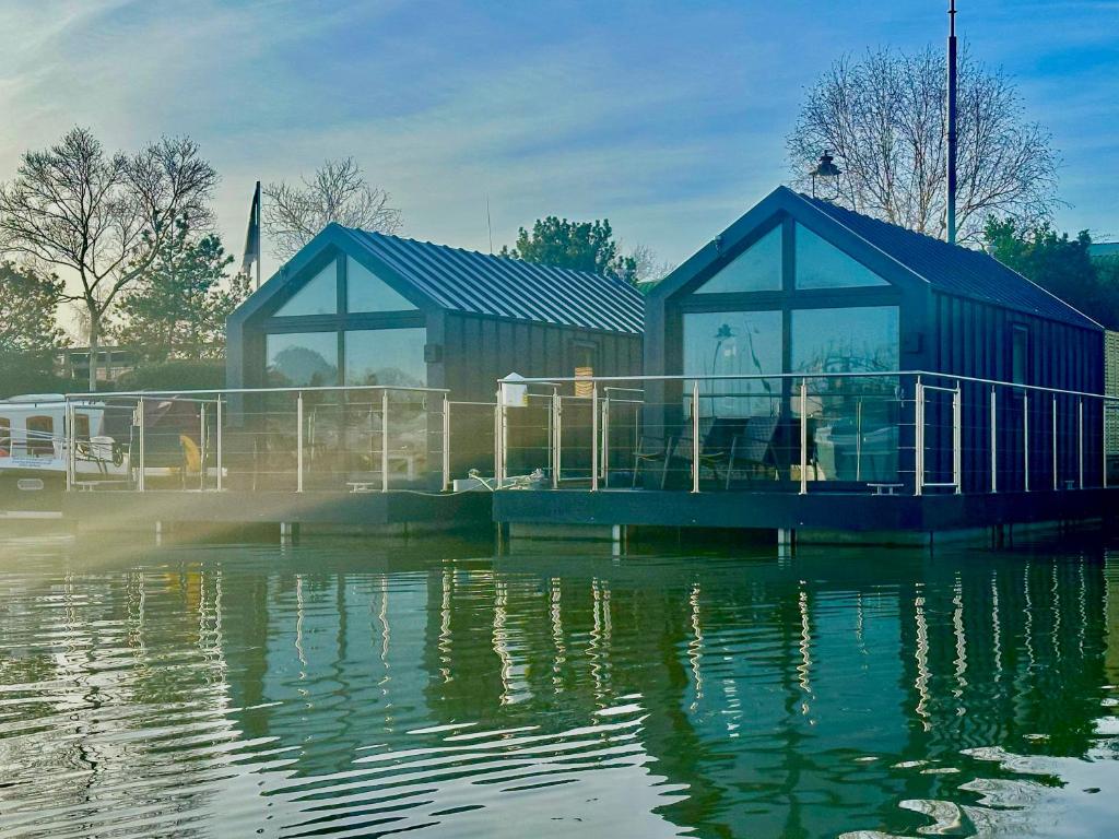 a couple of buildings sitting on top of a body of water at Floating Home at Burton Waters in Lincoln