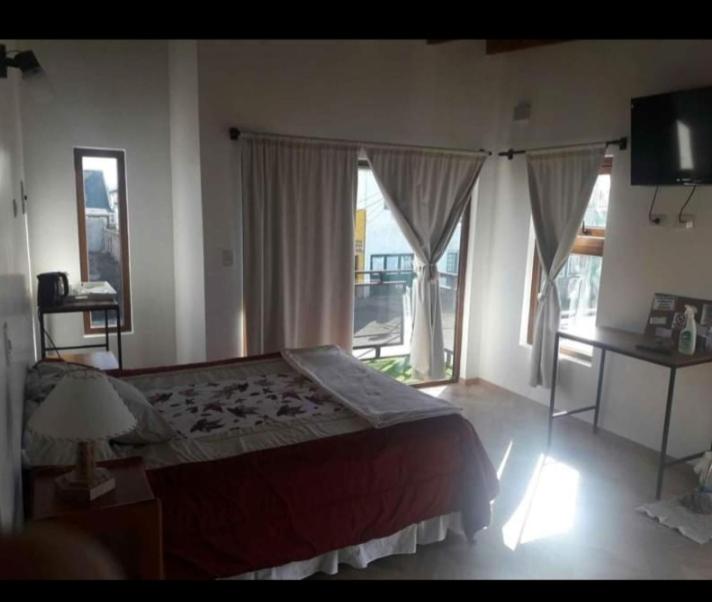 a bedroom with a large bed and a large window at SurRG in Río Grande