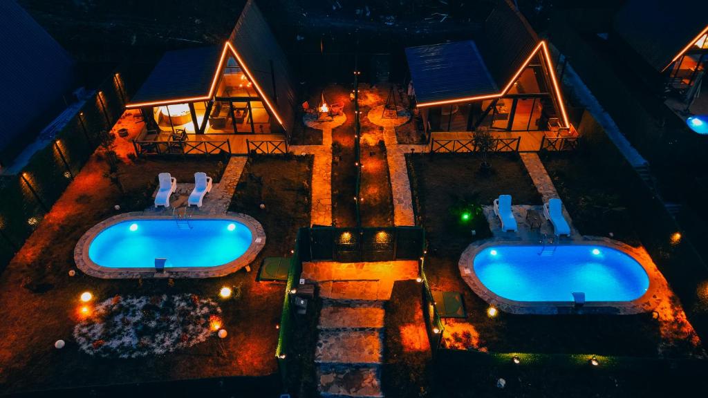 an aerial view of two swimming pools in front of a house at Mouna Sapanca in Sapanca