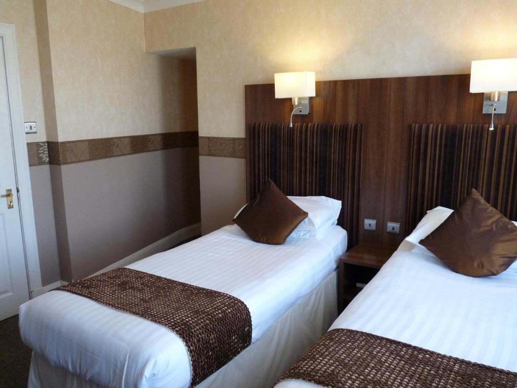 Postel nebo postele na pokoji v ubytování The Park Hotel