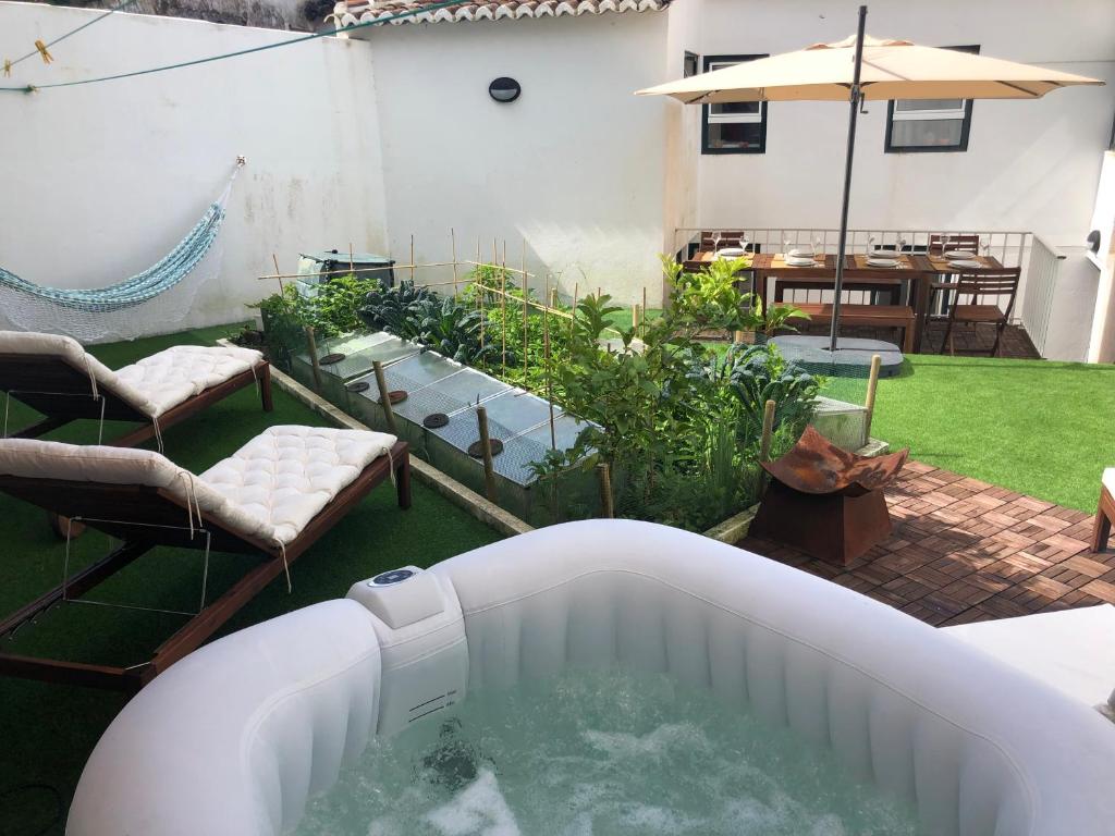 - un bain à remous dans une cour avec une terrasse dans l'établissement House in Angra do Heroísmo City Center, à Angra do Heroísmo