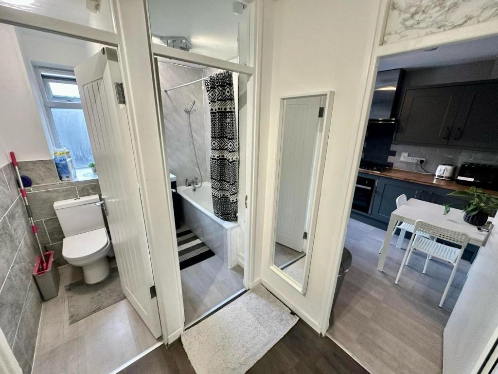 a bathroom with a shower and a toilet and a sink at Karen House R2 in London