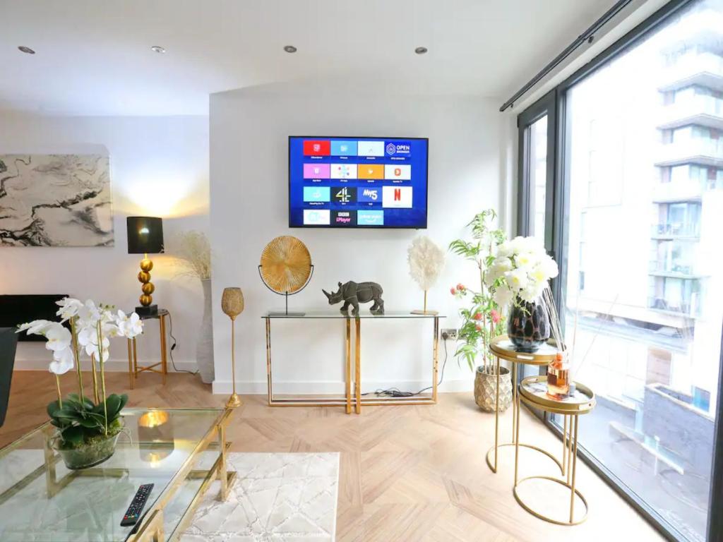 a living room with a tv on the wall at Pass the Keys Super King Penthouse Minutes from Arndale Centre in Manchester