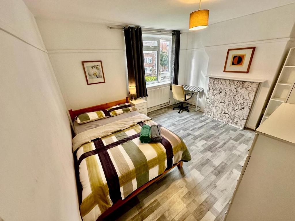 a bedroom with a bed and a fireplace at Aldgate East Rooms R1 in London