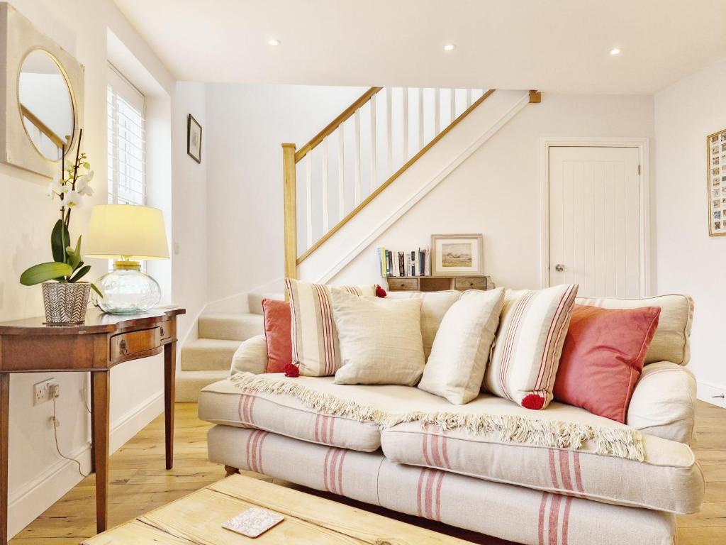 a living room with a white couch and stairs at Castleton , Chichester in Chichester