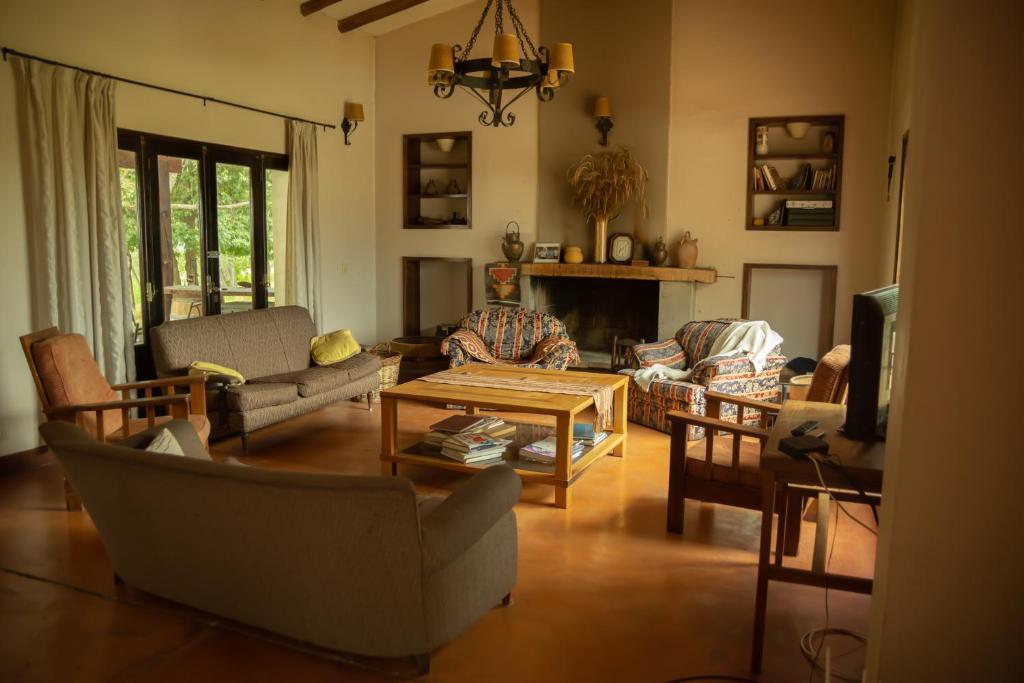a living room filled with furniture and a tv at La Martina. in Tunuyán