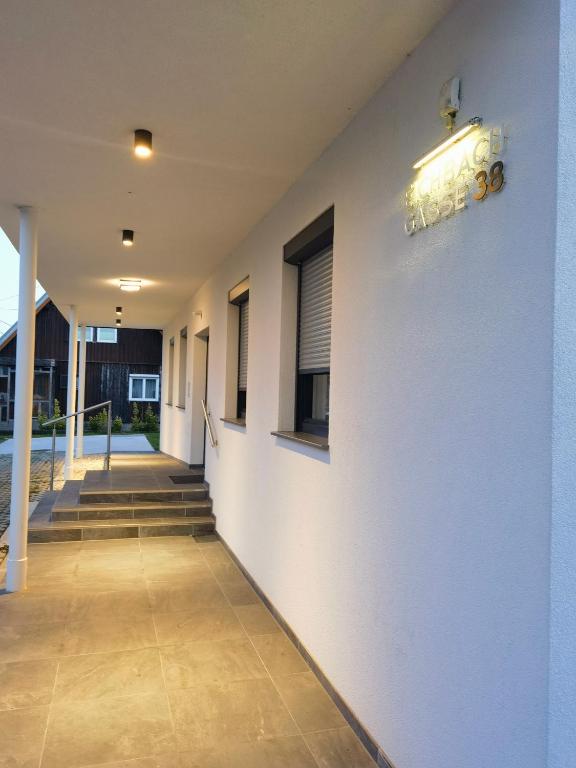 a hallway with stairs and a light on the wall at Eichbachgasse 38 in Graz