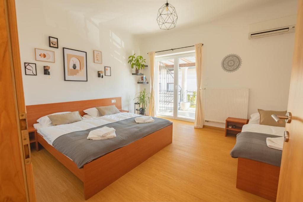 a bedroom with a bed and a window at VILA KLARA apartments in Ljubljana