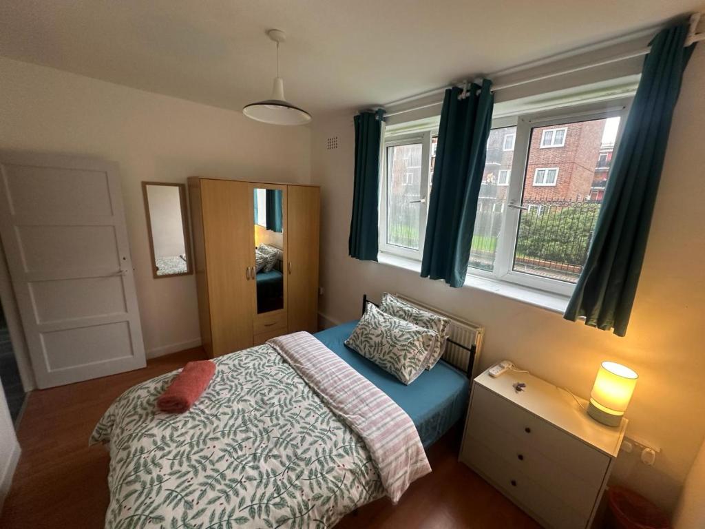 a small bedroom with a bed and a window at Shoreditch Rooms R1 in London