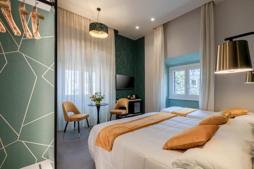 a bedroom with a large bed and a table and chairs at New Morpheus Rooms in Rome