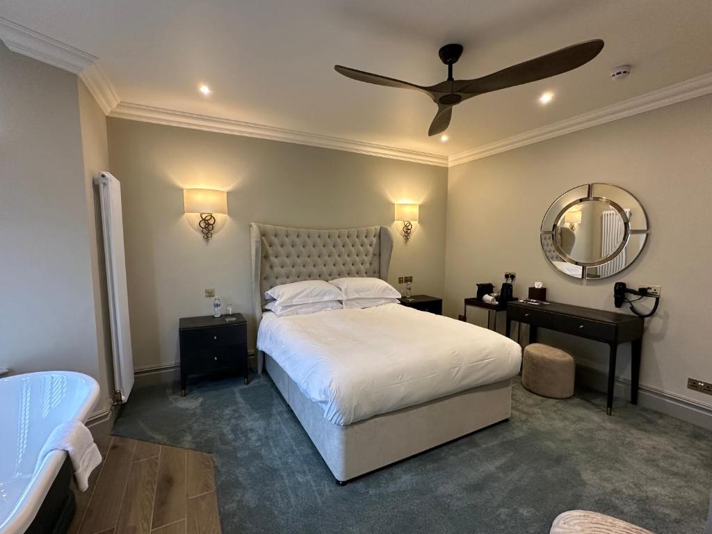 a bedroom with a bed and a ceiling fan at Number 46 in Hastings