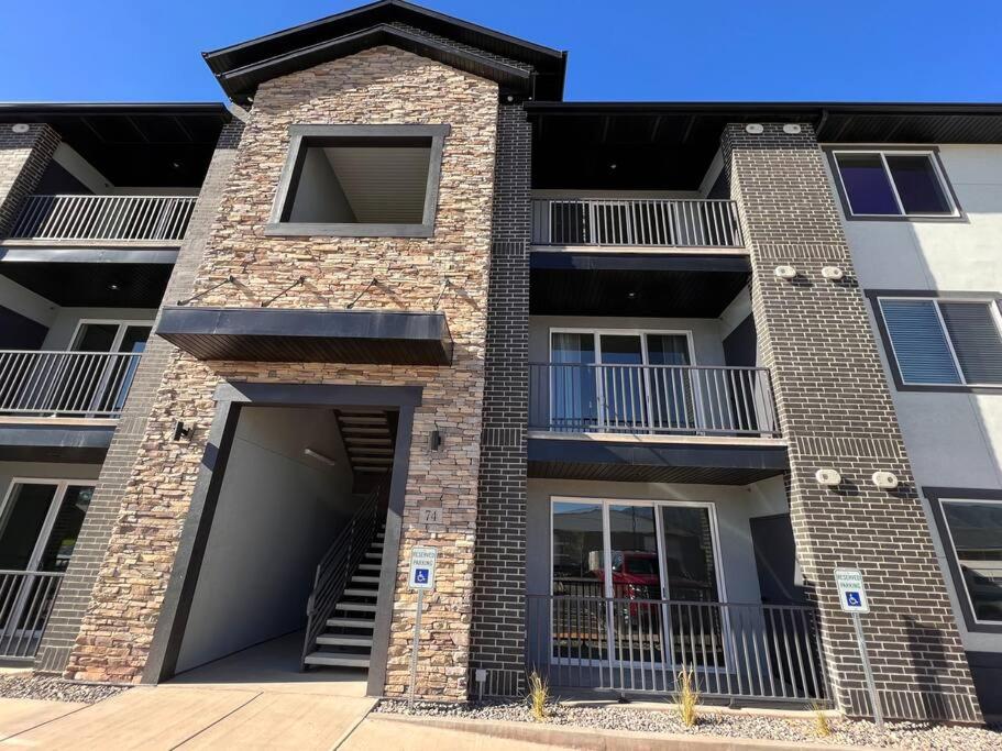 a large brick building with a garage and stairs at Richfield Loft Suite - Castle Rock Condos in Richfield