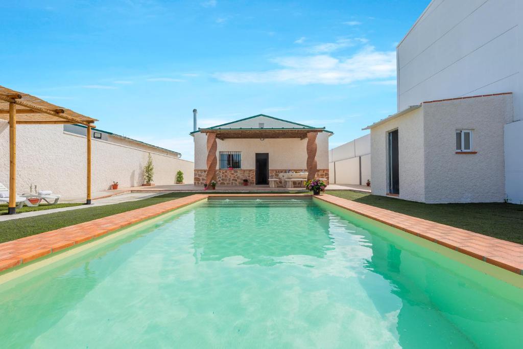 a swimming pool in the backyard of a house at Casa Rural Lola - Lantejuela in La Lantejuela