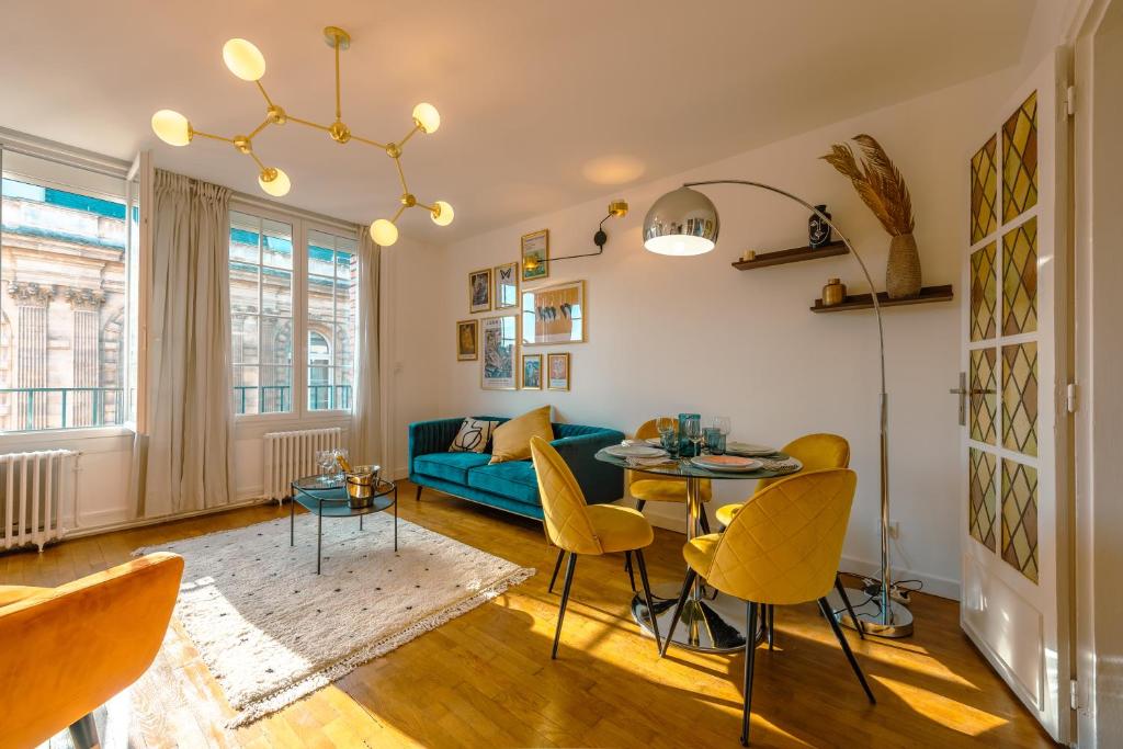 un salon avec un canapé bleu et une table dans l'établissement Luxueux 3ch - Hôtel de ville, à Amiens