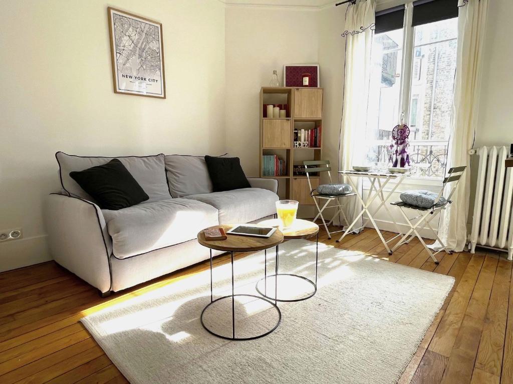un salon avec un canapé et une table dans l'établissement L' appartement Blomet, à Paris