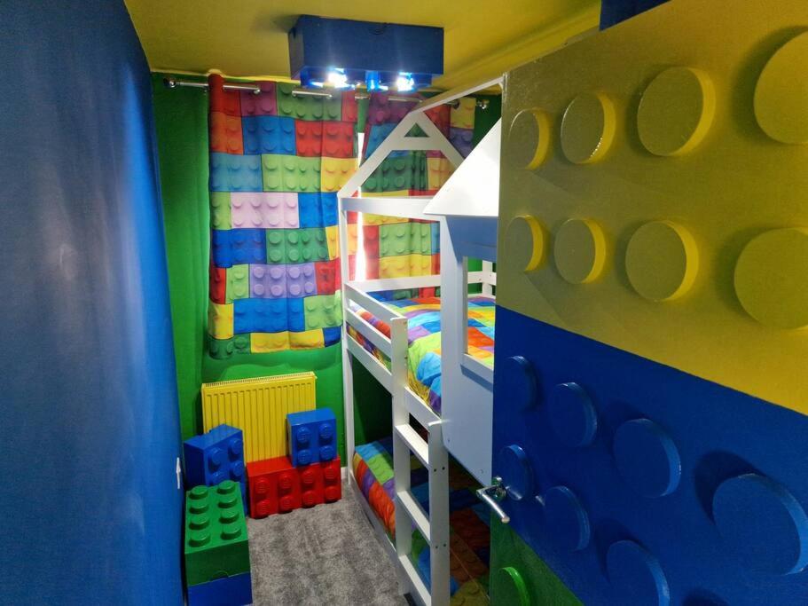 a childs room with a play room with a toy closet at The Lego themed house in Windsor