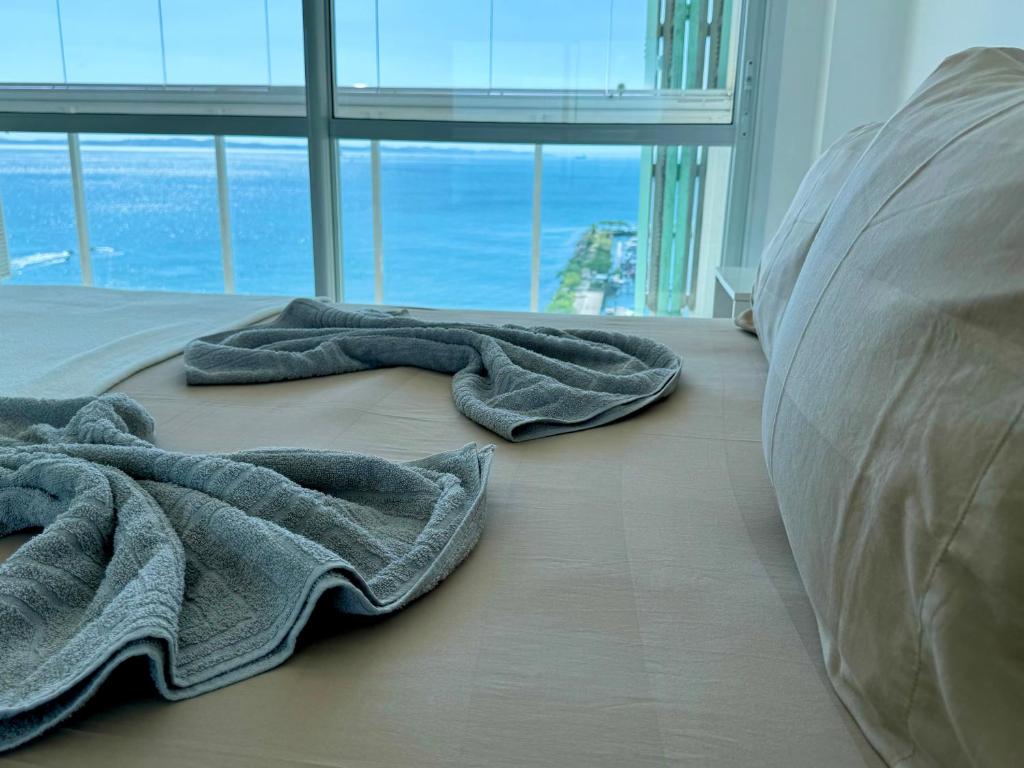 een slaapkamer met 2 handdoeken op de vloer bij Ap com vista mar - Cloc Marina! in Salvador