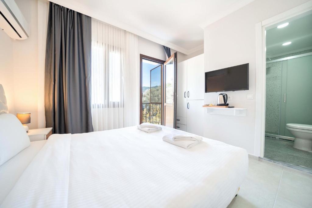 Postel nebo postele na pokoji v ubytování Dedeminn Garden Hotel