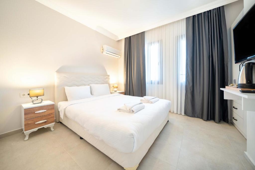 Postel nebo postele na pokoji v ubytování Dedeminn Garden Hotel