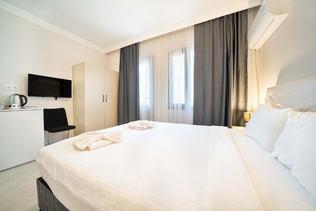 Postel nebo postele na pokoji v ubytování Dedeminn Garden Hotel