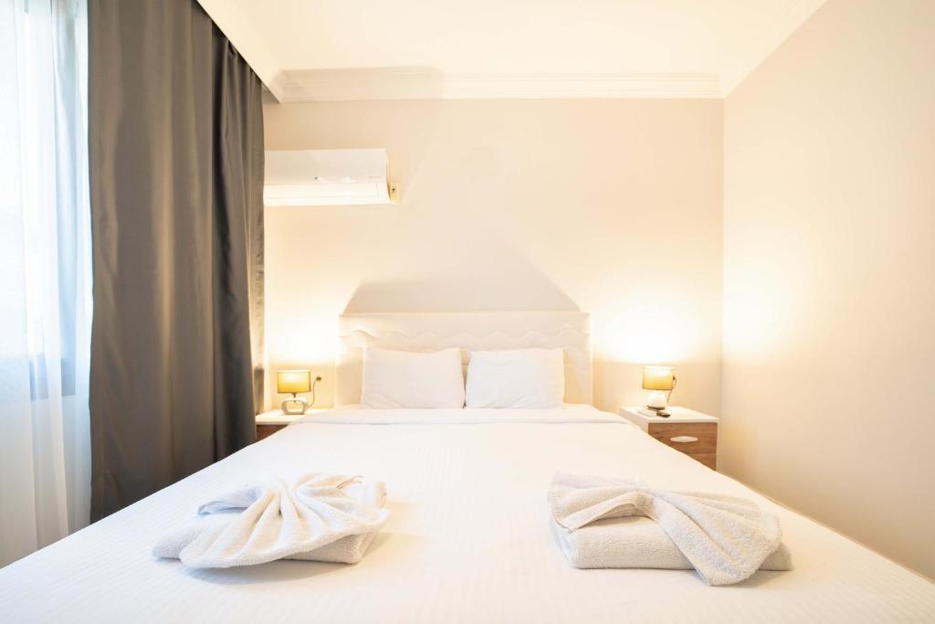 Postel nebo postele na pokoji v ubytování Dedeminn Garden Hotel