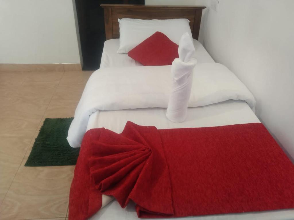 Postel nebo postele na pokoji v ubytování T-More Hotel & Hostel