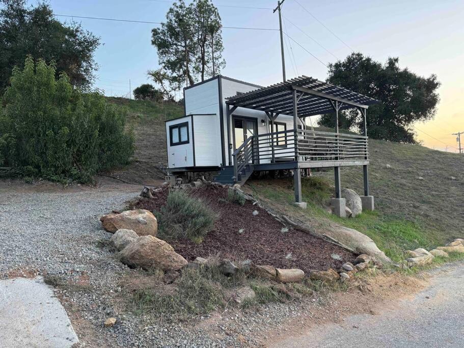 a tiny house sitting on top of a hill at Tiny House - mountain views close to everything in Valley Center