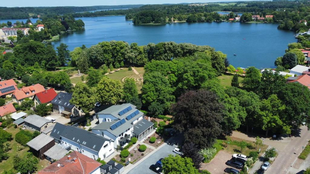 an aerial view of a house next to a lake at Ferienwohnungen Villa Ventil in Feldberg