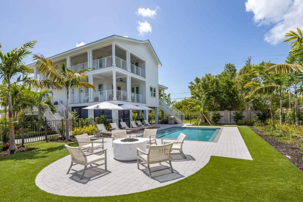 a villa with a swimming pool and lawn at The Crestwood House - Private Heated Pool & Parking in Key West