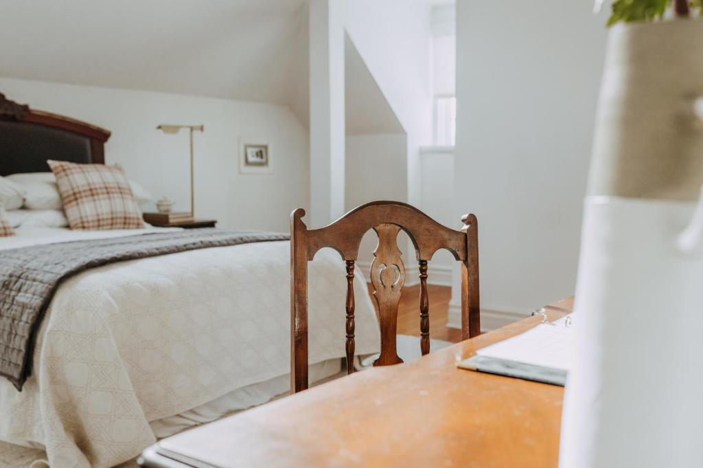 a bedroom with a bed and a wooden table at No. 5 East in Winnipeg