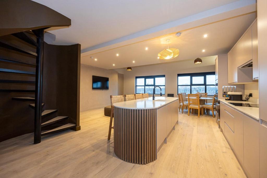 a kitchen and dining room with a large island in the middle at Atisuto Residence by CasaCity in Manchester