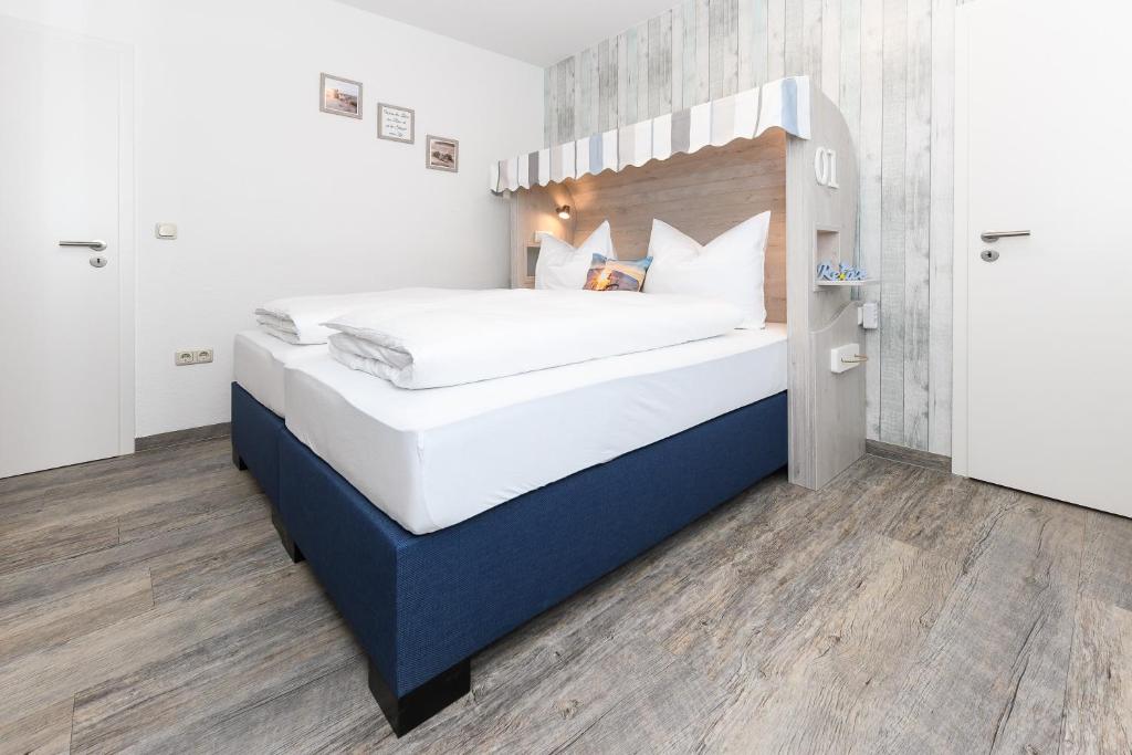 Postel nebo postele na pokoji v ubytování Haus Strandkorb mit Frühstücksoption