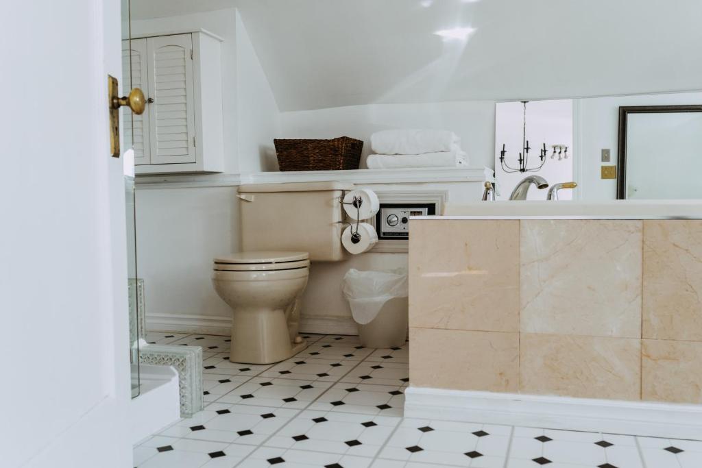 a bathroom with a toilet and a sink at No. 5 East in Winnipeg