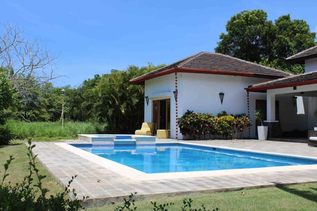 a swimming pool in front of a house at JuanDolio Guavaberry +3Brd 13p/p in Juan Dolio